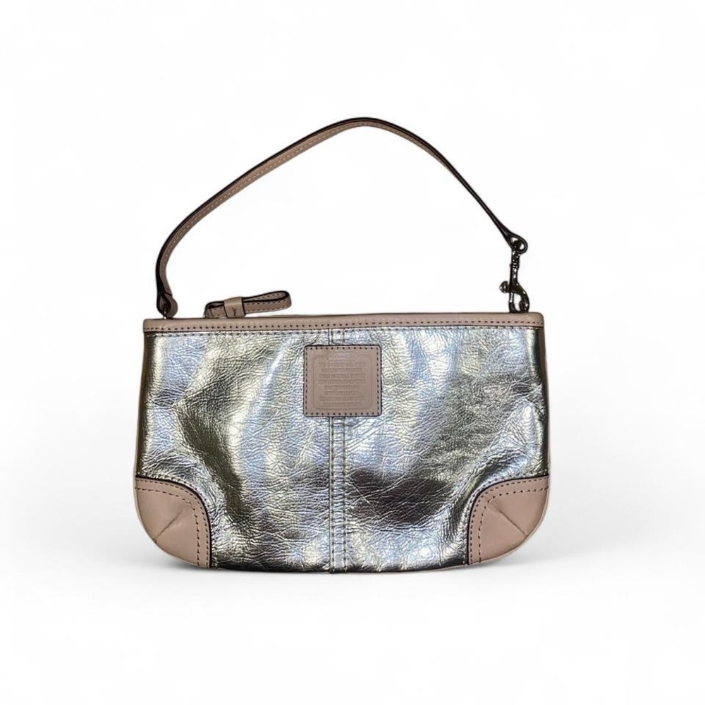 Coach metallic silver wristlet with beige detailing